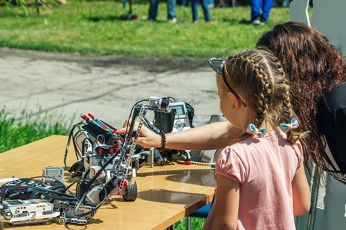 Young student learns about robotics through hands-on demonstrations